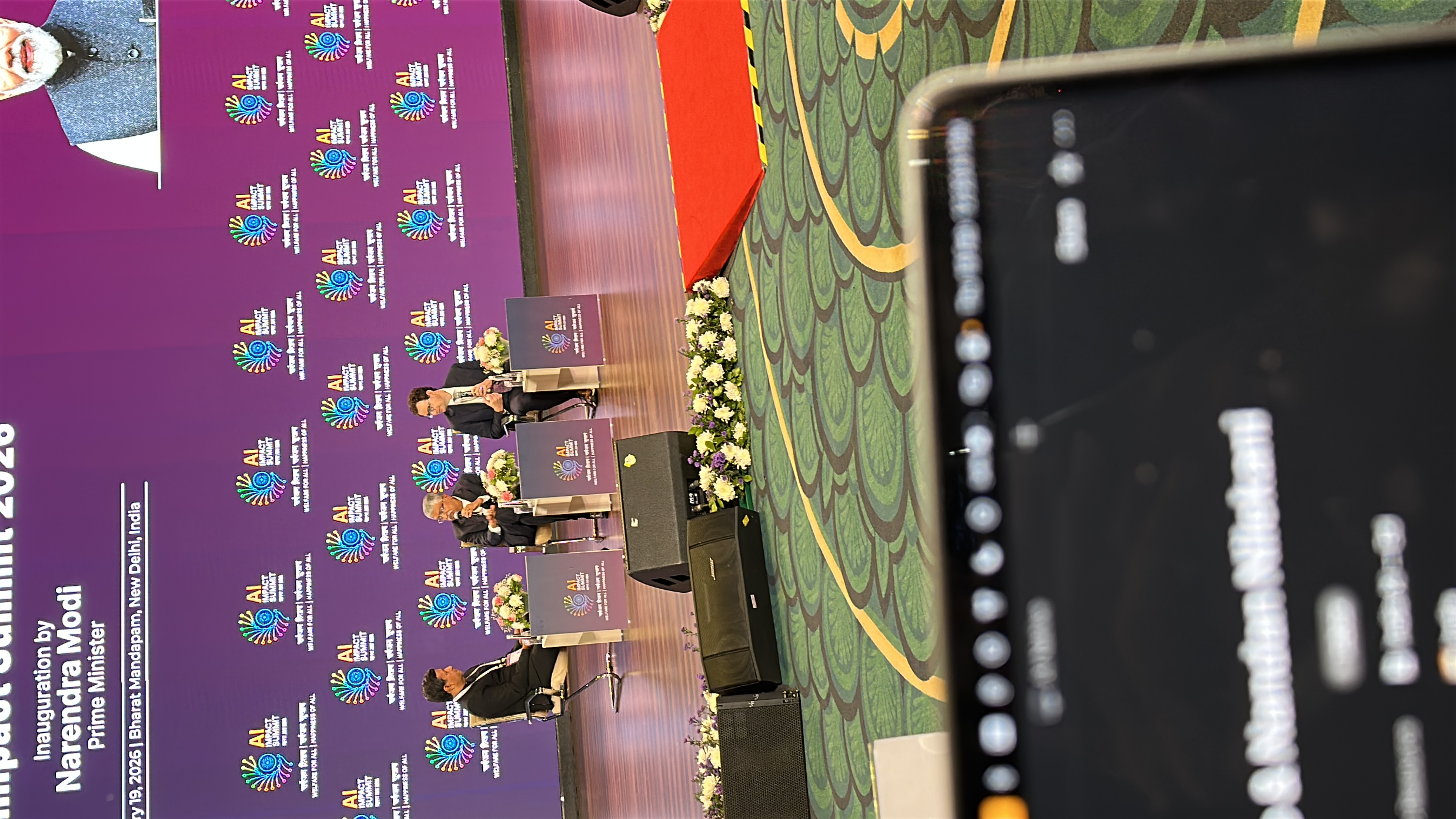 Dario Amodei and Nandan Nilekani on stage at the India AI Summit